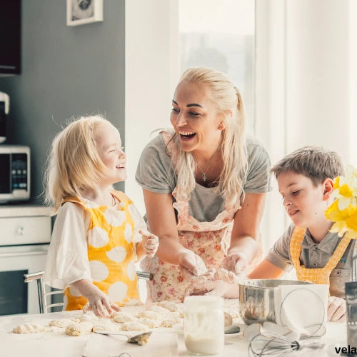 mum with two kids baking - case study for vela vacuum storage bags